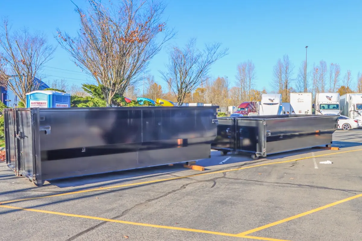 Professional dumpster rental service with roll-off container on residential driveway in Delaware